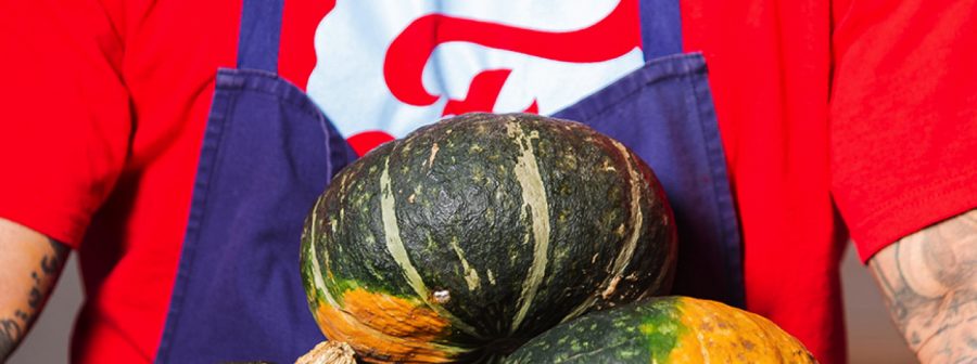 Farmly employee holding pumpkins