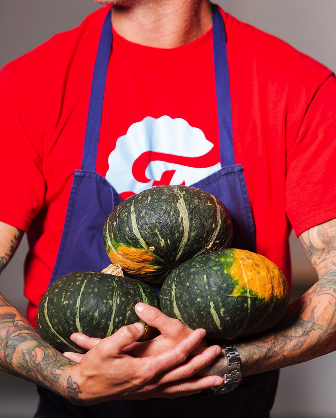 Farmly employee holding pumpkins