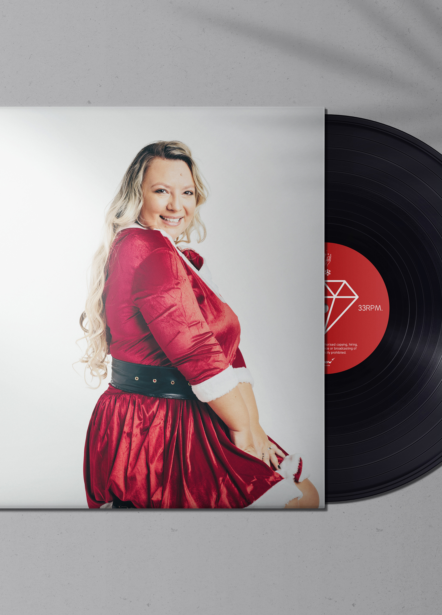 A woman in a red dress and a record.