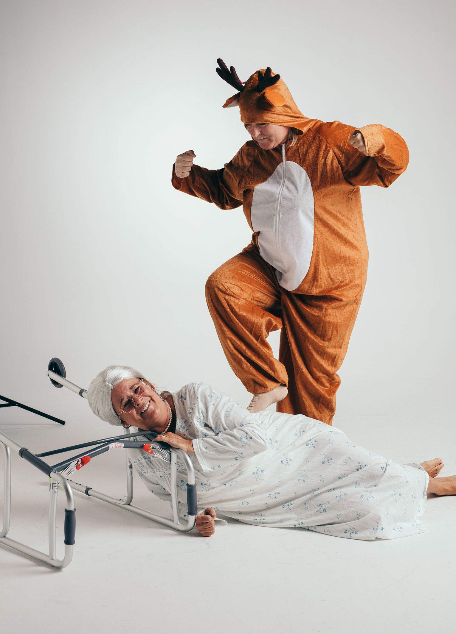 A man in a garment and a woman in a hospital bed.