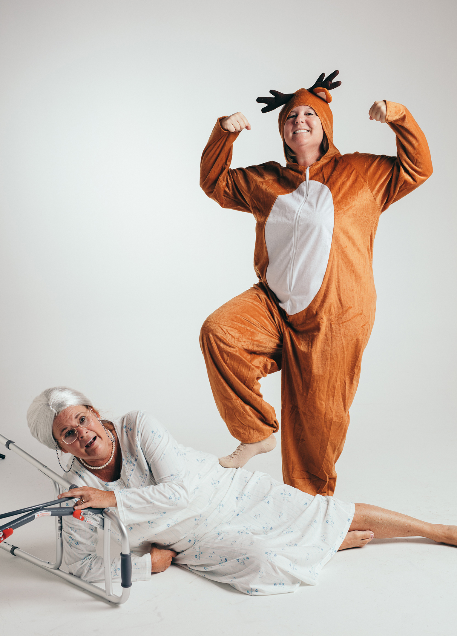 A woman in a reindeer garment and a woman in a walker.