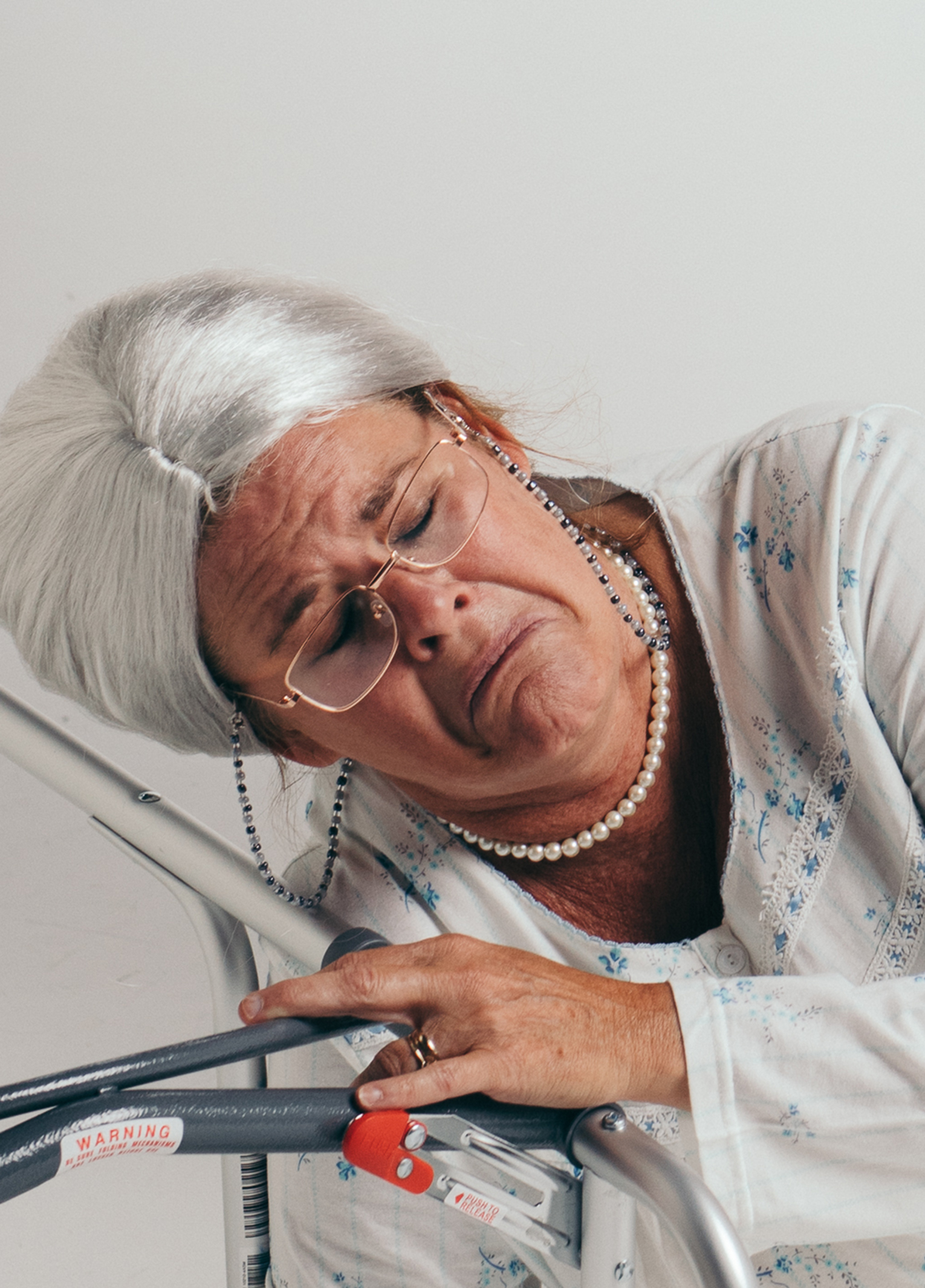 A woman leaning on a walker.
