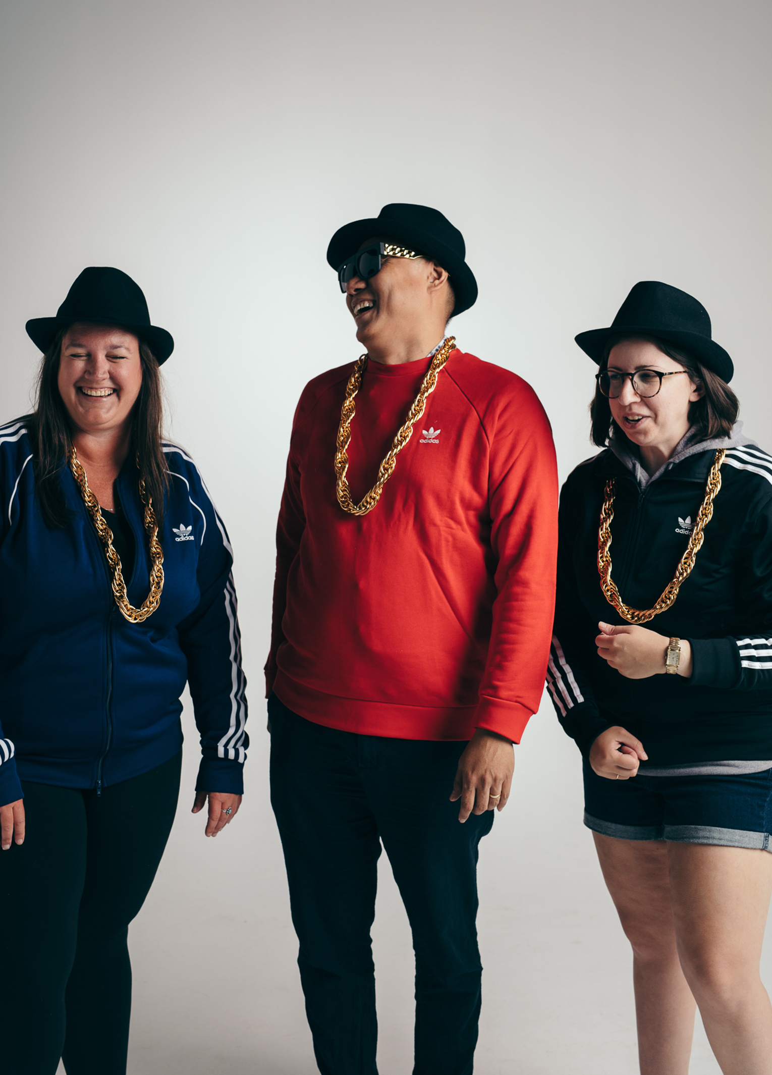 Three people posing for a photo in a studio.