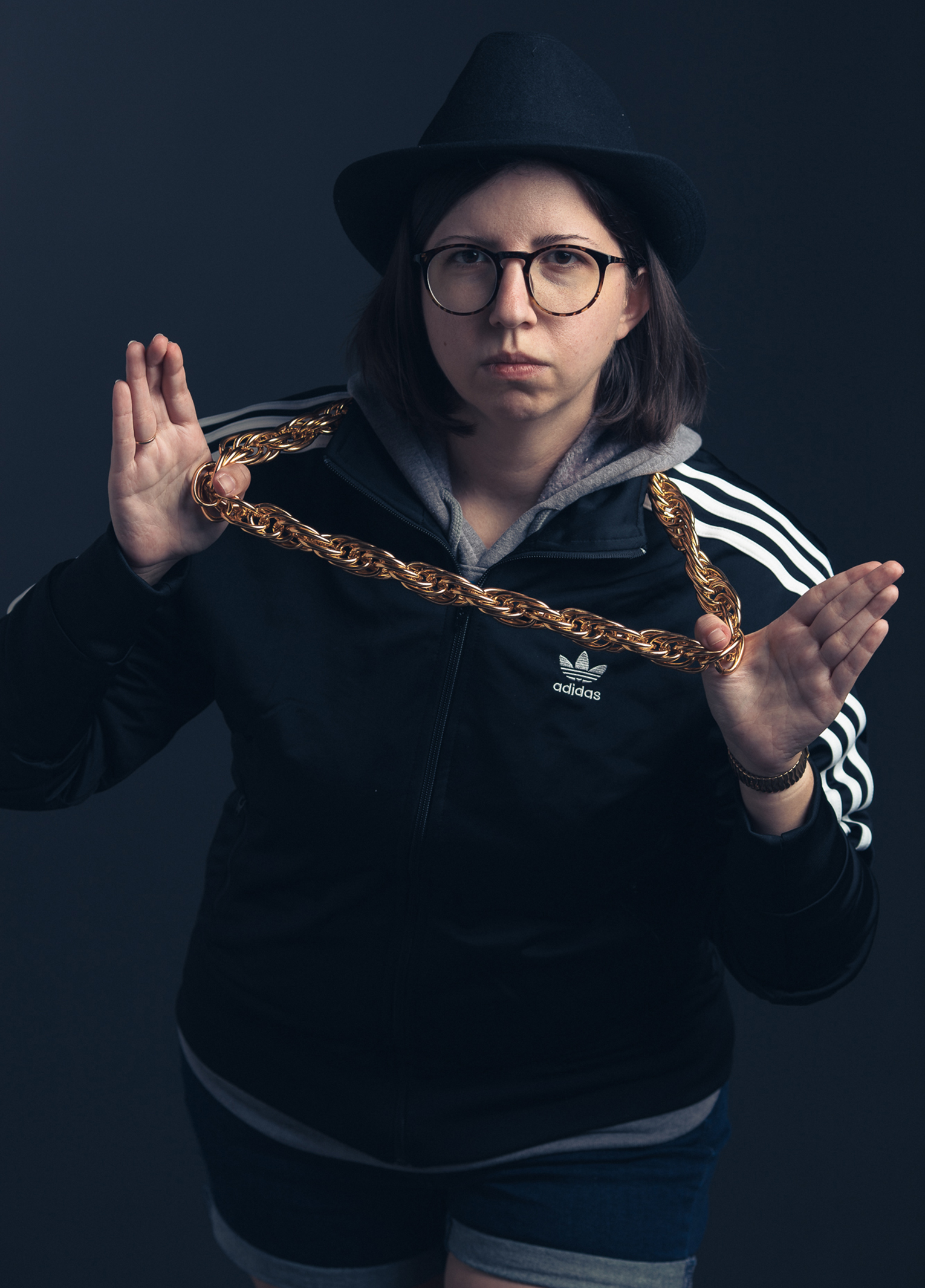 A woman wearing glasses and a hat.