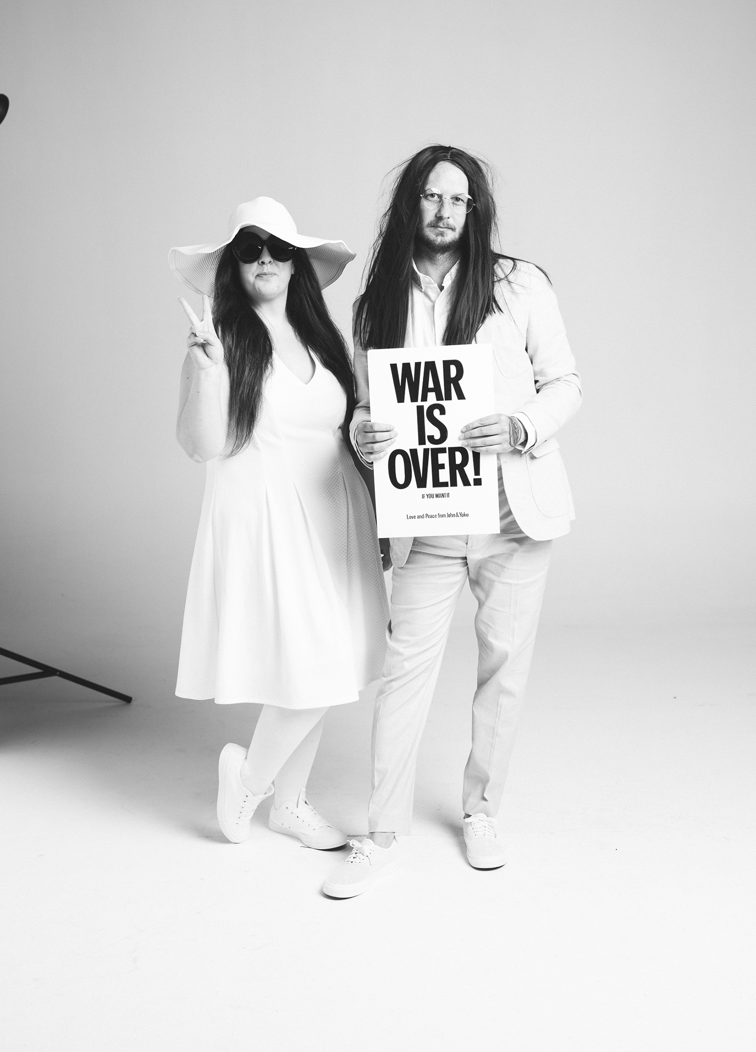 A man and woman holding a sign.