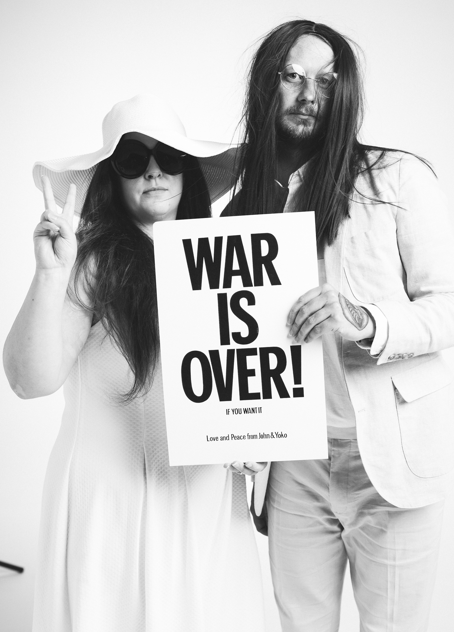 A man and woman holding a sign.