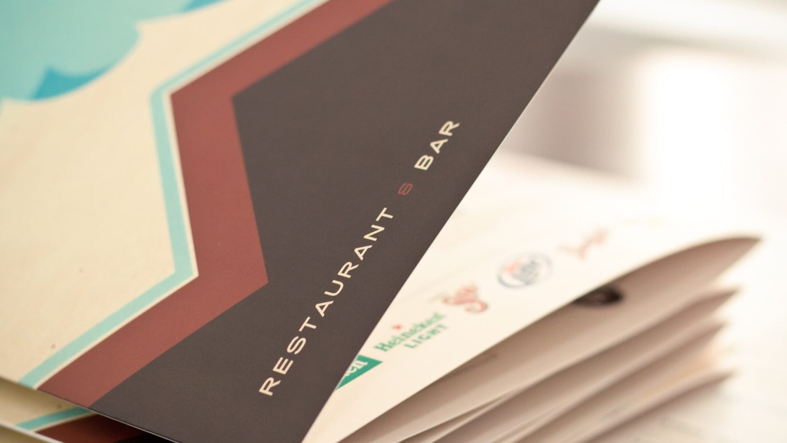 An open book with a restaurant logo on it.